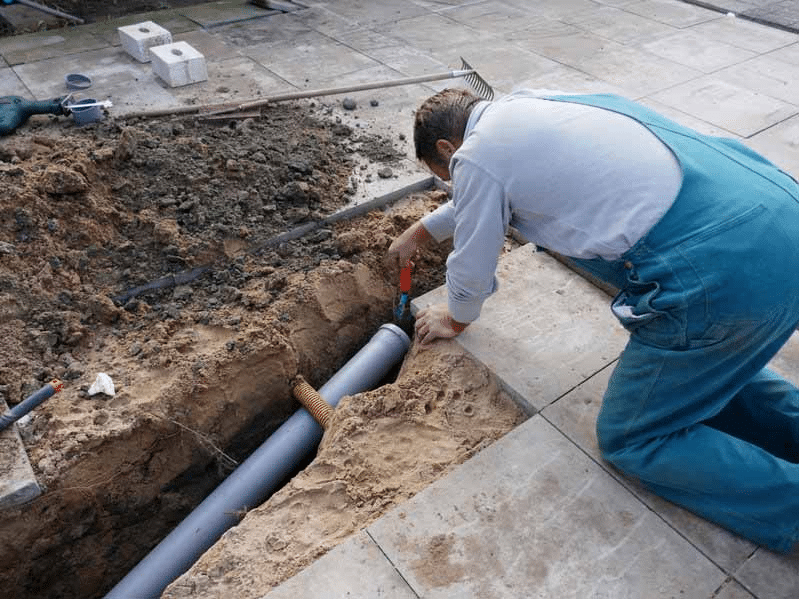 Plumber Installing a Sewer Line